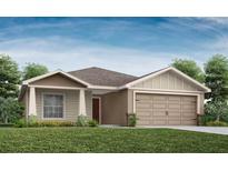 Charming single-story home with a two-car garage, well-maintained lawn, and inviting front entrance at 1809 Noble Dr, Davenport, FL 33837