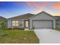 Charming single-story home boasts a manicured lawn and two-car garage at 1821 Thompson Preserve Boulevard, Bartow, FL 33830