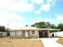 Charming single-story home with a covered carport and well-lit entry, perfect for easy access and curb appeal at 255 S Pennsylvania Ave, Lake Alfred, FL 33850