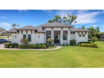 Stunning, contemporary-style home with manicured lawn and charming walkway at 2551 Delphi Woods Cir, Lakeland, FL 33812