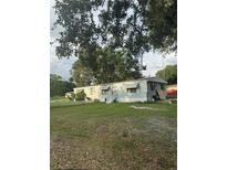 Charming single-story home with a well-maintained front yard and welcoming entryway with steps at 2621 Island Oaks W, Lakeland, FL 33805
