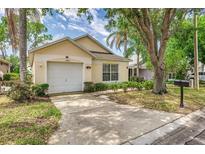 Charming single-story home featuring an attached garage and a well-manicured front yard at 2660 Hemingway Ave, Haines City, FL 33844