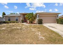 Charming single-story home with a two-car garage, complemented by a palm tree in the front yard at 2812 Hickory Ridge Dr, Lakeland, FL 33813