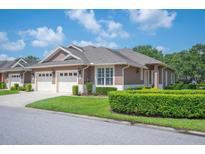 Charming single-story home features a well-manicured lawn and attached two-car garage at 2965 Mission Lakes Dr, Lakeland, FL 33803