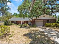Charming one-story brick home with an attached garage and mature landscaping, offering curb appeal at 3441 Sherertz Rd, Lakeland, FL 33810