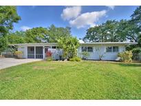 Charming single-story home with a well-maintained lawn and lush landscaping at 346 Tanager Ct, Lakeland, FL 33803