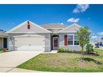 Charming single-Gathering home with a well-manicured lawn, attached garage, and classic architectural details at 4203 San Rocco Way, Winter Haven, FL 33884