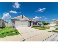 Charming single-story home featuring a two-car garage, manicured lawn, and inviting curb appeal at 4203 San Rocco Way, Winter Haven, FL 33884