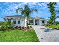 Beautifully landscaped one-story home with a well-manicured lawn and a brick driveway, inviting and full of curb appeal at 5390 Clubhouse Hills Ln, Lakeland, FL 33812