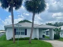Charming single-story home with a covered carport and lush landscaping including palm trees at 602 Avery Ln # 602, Lakeland, FL 33803