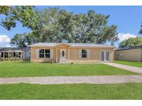 Charming single-story home featuring a well-manicured lawn and a classic front facade at 7208 Thomas Jefferson Cir, Bartow, FL 33830
