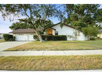 Charming single-story home featuring a well-manicured lawn and an attached two-car garage at 781 Bryson Loop, Lakeland, FL 33809
