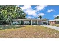 Charming single-story home with a carport and mature landscaping in a quiet neighborhood at 118 Lake Sears Dr, Winter Haven, FL 33880