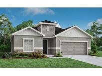 Charming single-Gathering home with a manicured lawn and attached two-car garage at 1806 Teleford Rd, St Cloud, FL 34771