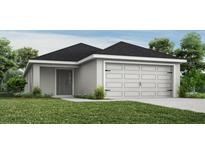 Charming single-story home with a two-car garage and neutral paint scheme, blending seamlessly with the surrounding landscape at 2206 Oldham Ct, Haines City, FL 33844
