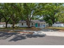 Charming single-story home featuring a well-manicured lawn and inviting curb appeal with mature trees at 315 Eastway Dr, Lakeland, FL 33803