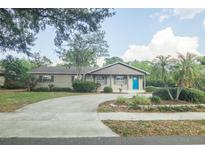 Charming single-story home with a well-maintained lawn and a bright blue front door at 4008 S Carlisle Rd, Lakeland, FL 33813