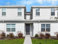 Charming two-story home featuring low-maintenance landscaping and a welcoming front door at 5776 Freshwater Canyon Dr, St Cloud, FL 34771