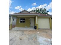 Charming one story home with front porch, vinyl siding and attached one car garage at 625 W 9Th St, Lakeland, FL 33805