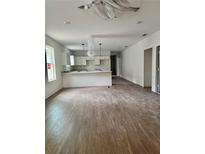 Bright living room features modern flooring, white walls, and an open layout to the kitchen at 625 W 9Th St, Lakeland, FL 33805