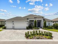 Stunning single-story home featuring a three-car garage and a beautifully landscaped front yard at 6777 Bentridge Dr, Lakeland, FL 33813