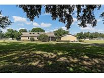 Charming single story home boasts a sprawling lawn and separate detached garage at 7721 Forest Way, Lakeland, FL 33810