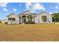 Charming single-story home with well-manicured landscaping and inviting front entrance at 8909 N Campbell Rd, Lakeland, FL 33810