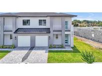 New construction with modern design, two-car garage, and manicured landscaping for a stylish home at 1171 Windjammer Dr, Lakeland, FL 33803
