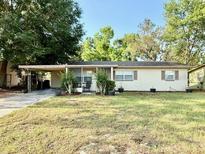 Charming one-story home with mature trees and well-maintained lawn, providing great curb appeal at 135 E Columbia St, Lake Alfred, FL 33850