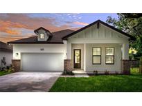 Inviting exterior view of a charming single-Gathering home featuring a manicured lawn and attached two-car garage at 1415 S Lincoln Ave, Lakeland, FL 33803