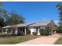 Charming single-story home with well-maintained landscaping and a brick-paved driveway leading to the entrance at 16 Golfview Ne Cir, Winter Haven, FL 33881