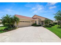 Inviting single-story home with a well-manicured lawn, tile roof, and a spacious driveway at 1772 Laurel Glen Pl, Lakeland, FL 33803