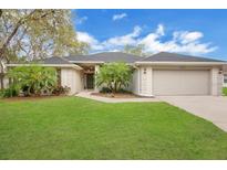 Beautiful single-story home with well-maintained landscaping and a two-car garage at 1837 Farrington Dr, Lakeland, FL 33809