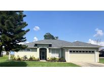 Charming one-story home featuring a well-maintained lawn and a two-car garage at 200 S Goodman Ave, Lake Alfred, FL 33850