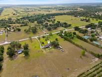 Expansive aerial view of property with a house, outbuildings, and abundant surrounding land at 2500 Brooke Rd, Fort Meade, FL 33841