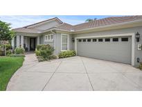 Charming home featuring a side-entry garage and lush landscaping at 2569 Laurel Glen Dr, Lakeland, FL 33803