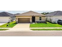 Charming single-story home featuring a well-manicured lawn and a two-car garage at 297 Spirit Landings Cir, Winter Haven, FL 33880