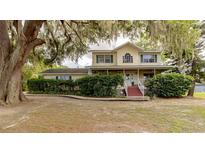 Charming two-story home with a covered porch and mature trees in a peaceful setting at 330 W Palmetto St, Lakeland, FL 33815