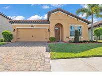 Charming single-story home with a two-car garage, well-manicured lawn, and inviting curb appeal at 4088 Prima Lago Cir, Lakeland, FL 33810