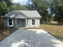 Charming single-story home featuring a freshly poured driveway and verdant landscaping at 420 S 9Th Ave, Bartow, FL 33830