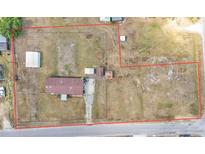 Sprawling property featuring a mobile home, outbuildings, and extensive fenced yard space from an aerial view at 4207 Ollie Rd, Lakeland, FL 33810