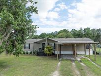 Charming single story home with a covered entrance and a matching covered carport at 5339 Meadow Grove Trl, Lakeland, FL 33810