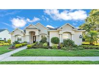 Charming single-story home featuring a beautifully landscaped yard and welcoming front entrance with classic architectural details at 6546 Eagle View Loop, Lakeland, FL 33813