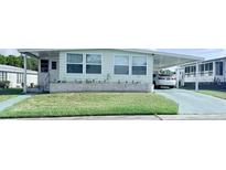 Charming single-story home featuring a well-maintained lawn and covered parking at 816 Elizabeth Ln, Lakeland, FL 33809