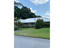 Charming single-story home with a well-manicured lawn and a neatly arranged landscape at 1110 Cypress W Pt, Winter Haven, FL 33884