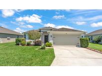 Charming single-story home with a well-manicured lawn and an attached two-car garage at 1215 Evergreen Park Cir, Lakeland, FL 33813