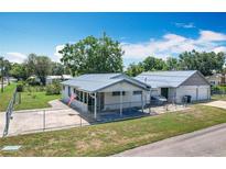 Charming single-story home with a metal roof, fenced yard and screened porch at 1405 Clinton St, Bartow, FL 33830