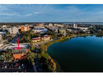 Aerial view of a brick building on a lake in the middle of a city at 200 Lake Morton Dr # 100, Lakeland, FL 33801