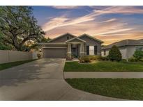Charming single-story home featuring a manicured lawn, stone accents and an attached two car garage at 280 Pershing St, Bartow, FL 33830