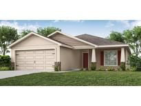Charming single-story home features a two-car garage, well-manicured lawn, and inviting entryway at 5432 Se 127Th Ln, Belleview, FL 34420